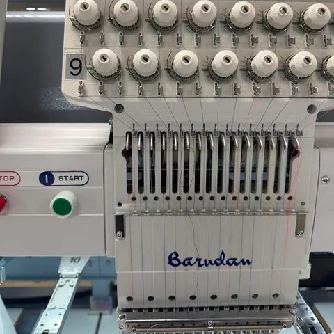 Barudan sewing head with its needle bars and start and stop buttons