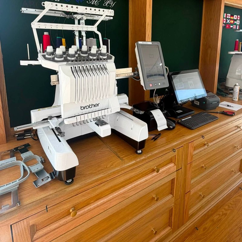 Brother multi-needle embroidery machine with its touch screen on a counter
