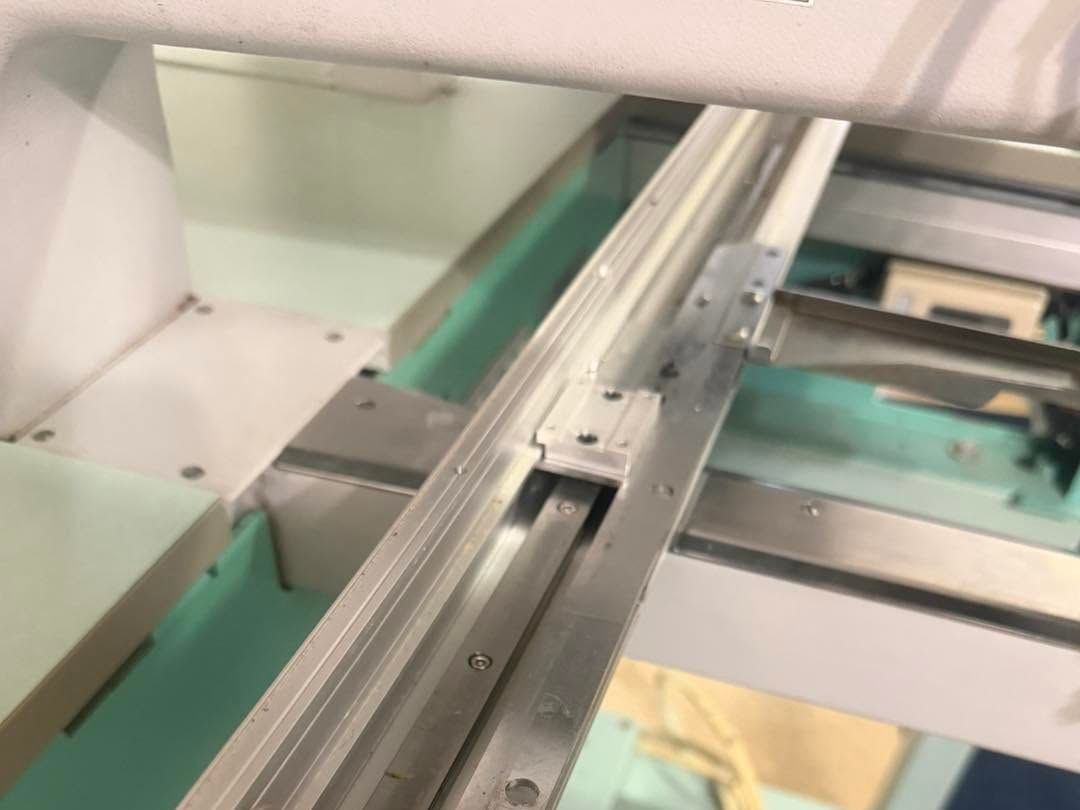 Belt pulley and pantograph arm on an embroidery machine X-axis rail