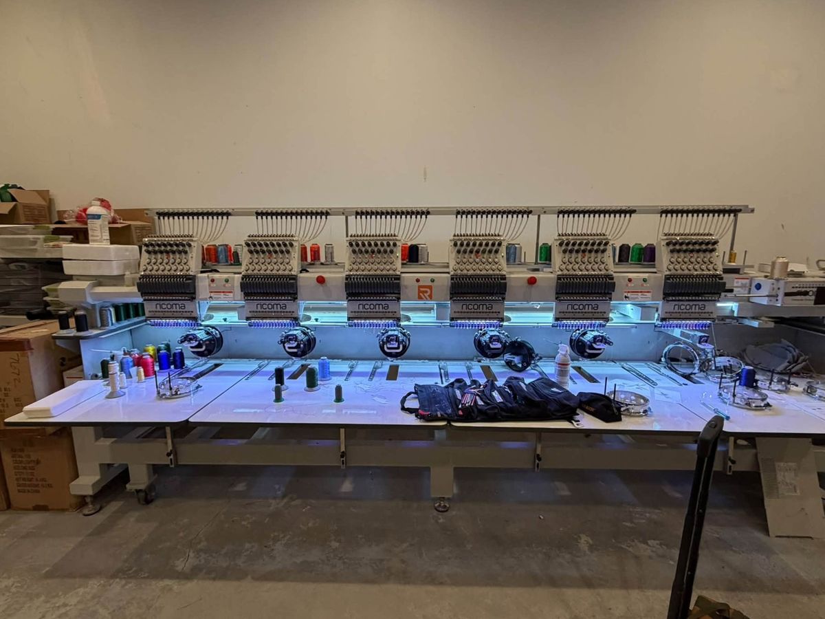 Six-head Ricoma in a warehouse with tool rolls laid on its table