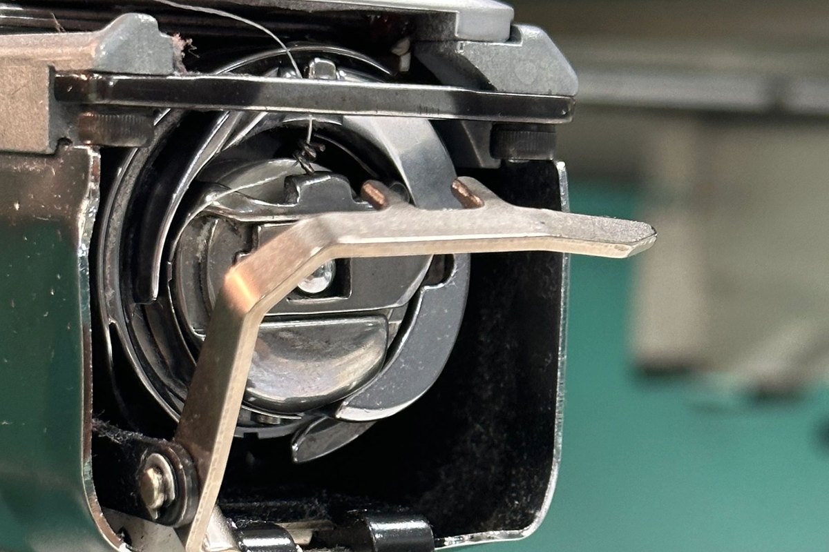 Rotary hook and bobbin area of an embroidery machine, up close