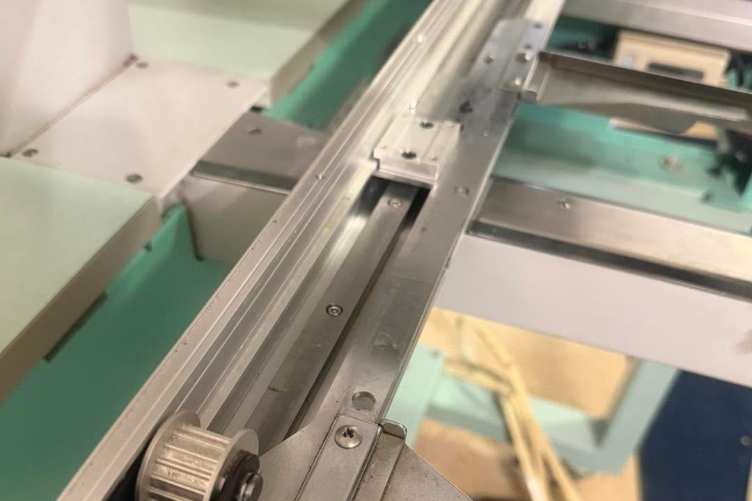 Close view of the X-axis rail, belt pulley, and pantograph bracket