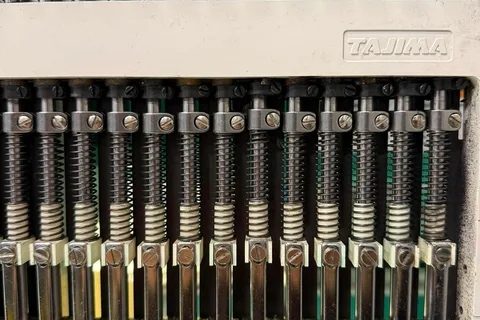 Tajima needle bars and springs with the head cover removed
