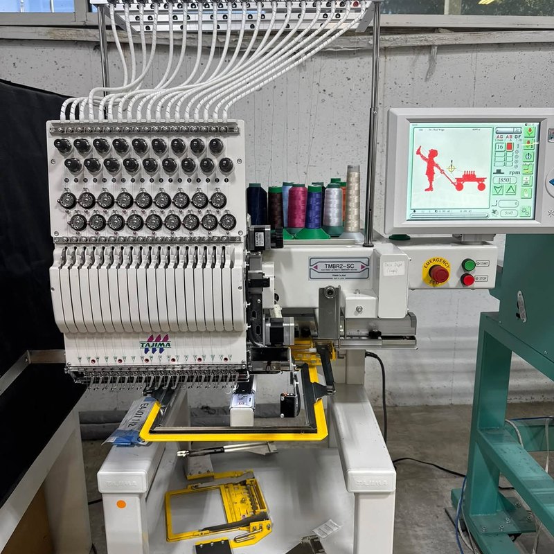 Single-head Tajima TMBR2-SC embroidery machine with a design showing on its touchscreen